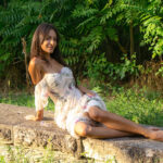 girl posing sitting in a white dress